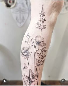 a black and white flower tattoo on the right leg, with flowers growing out of it