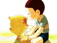 a young boy sitting on the ground with a stuffed animal in his lap and looking at it