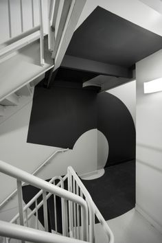 a black and white photo of a spiral staircase