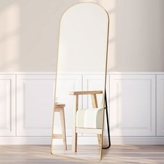 an empty chair sitting in front of a large mirror on the floor next to a table