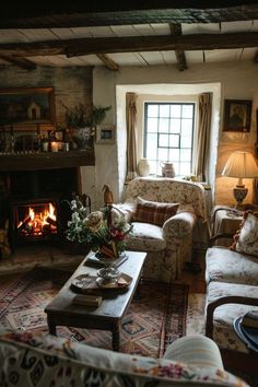 a living room filled with furniture and a fire place next to a window in front of a fireplace