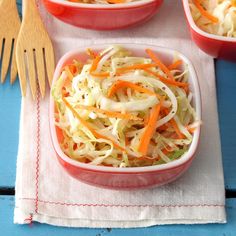 three bowls filled with coleslaw and carrots on top of a blue table