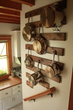 pots and pans are hanging on the wall