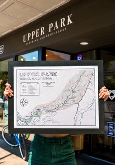 woman holding a black picture frame with the upper bidwell park map poster print inside. model is standing in front of upper park in downtown chico, california. Park Trails, Swimming Holes, Bike Trails, Map Poster, Vintage Poster, Matte Paper, State Parks, Vintage Posters, Poster Print