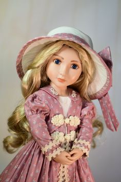 a doll with blonde hair wearing a pink dress and hat, holding a flower bouquet