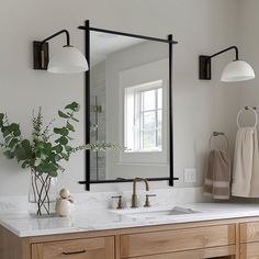 a bathroom with two sinks and a large mirror on the wall over it's sink