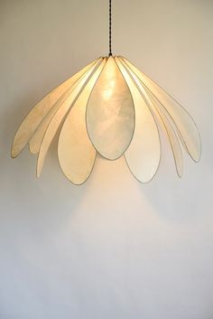 a light that is hanging from the ceiling with some lights on it's sides