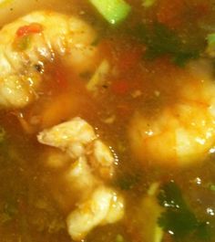 a close up view of soup with shrimp and broccoli