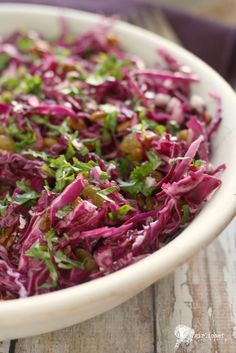 a white bowl filled with red cabbage salad