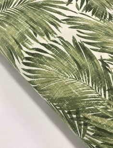 a green and white palm leaf print fabric