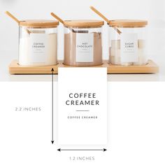 three coffee creamers with labels on them sitting next to each other in front of a white background