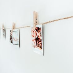 three pictures hanging on a rope with clothes pins