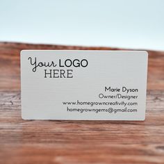 a business card sitting on top of a wooden table