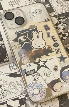 an iphone case with stickers on it and some other things in front of it