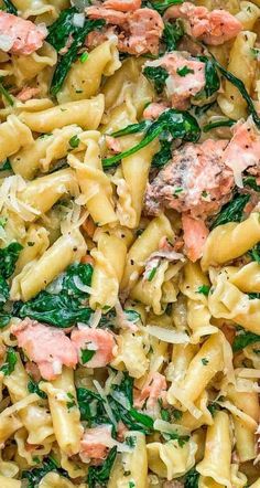 pasta with salmon and spinach in a white bowl