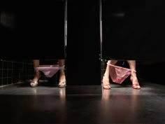 two people standing in the middle of a room with their feet on a toilet seat