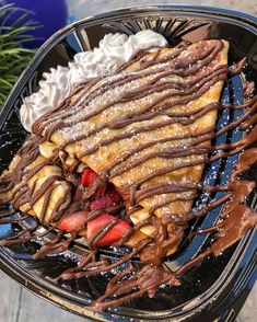 there is a large pastry covered in chocolate and strawberries