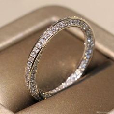 a diamond ring sitting on top of an open cell phone