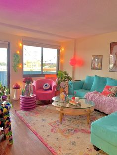 a living room filled with lots of furniture and colorful decor on top of a wooden floor