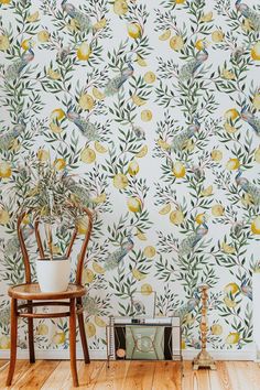 the wall paper has birds and lemons on it, along with a potted plant