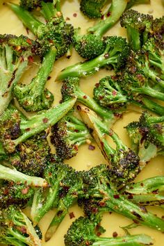 broccoli florets are being cooked in a pan with mustard and seasoning