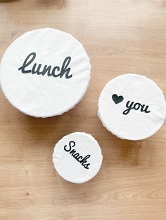 three personalized coasters sitting on top of a wooden table