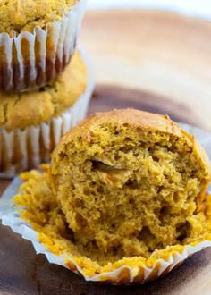 two muffins sitting on top of a wooden plate