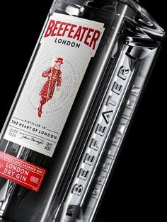 a bottle of beefeater london dry gin on a black background with red lettering