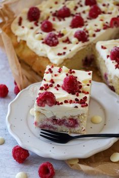 a slice of raspberry cheesecake on a plate with a fork next to it