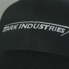 the back of a black hat with white lettering on it that says stark industriess