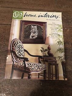 the front cover of a magazine with a zebra print chair and side table in it