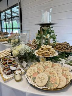 a table topped with lots of cookies and desserts