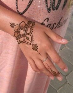 a woman's hand with hennap on her left arm and the word love written