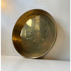 A round brass tray that has developed a rich and raw patina over the years. It was made during the 1970s by cawa in denmark in a style reminiscent of josef frank and stelton. It is suitable for serving drinks or as a 1-2 person breakfast tray. It has an inscription to its center saying: 'thanks for 7 years as our teacher' in danish obviously. measurements: d: 29 cm, h: 4 cm. This piece has an attribution mark,   i am sure that it is completely authentic and  take full responsibility for any auth Brass Serving Tray, Hammered Brass Tray, Breakfast Tray, Brass Tray, Serving Drinks, Danish Modern, 1970s, Over The Years, Tray