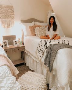 a woman sitting on top of a bed in a bedroom