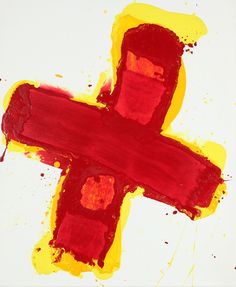 a cross painted in red and yellow on a white background