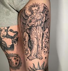 a man with tattoos on his legs and arm is holding an angel in the air