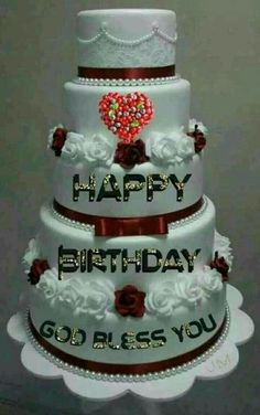 a three tiered cake with roses and hearts on it that says happy birthday go blessing you