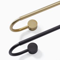 an assortment of brass and black handles on a white background