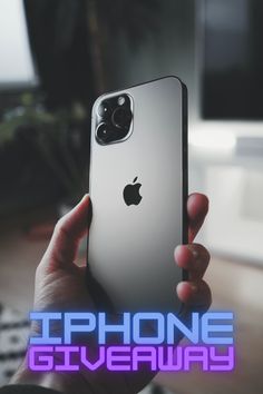 a person holding an iphone in their hand with the words iphone giveaway on it