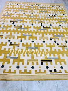 a yellow and black area rug with the word happiness written in gold letters on it