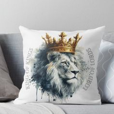 a lion with a crown on it's head sitting on top of a couch