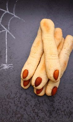 some kind of food that is on top of a chalkboard with the words halloween recipe ghoulih fingers