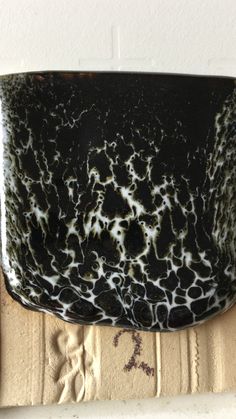 a black and white bowl sitting on top of a counter