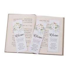 two bookmarks with the words welcome and flowers on them are sitting in an open book