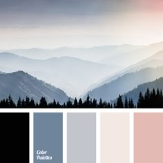 the mountains are covered in fog and light blue, pink, and grey hues