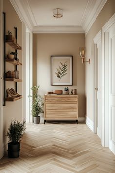 an empty hallway with a wooden cabinet and potted plants on the shelf next to it