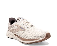 a woman's white and brown running shoe