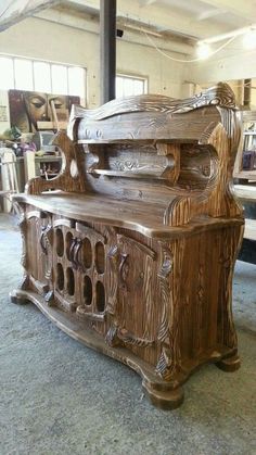 an old wooden bench sitting in the middle of a room