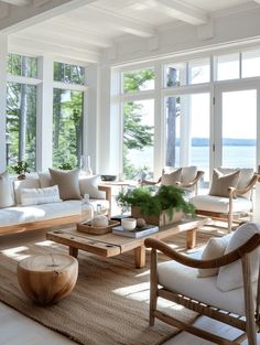 a living room filled with lots of furniture next to large windows and wooden tables on top of carpeted flooring